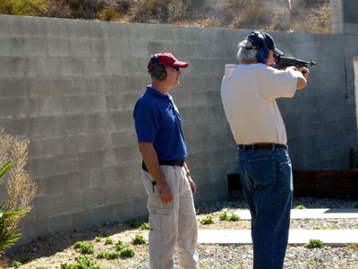 Firing a 1930s era Tommy Gun at the FBI firing range with a an FBI instructor looking on